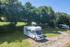 Electric hardstanding and grass pitches with shady spots