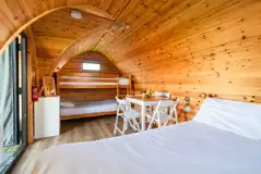 Camping pod interior with electric, a table, chairs and radiator