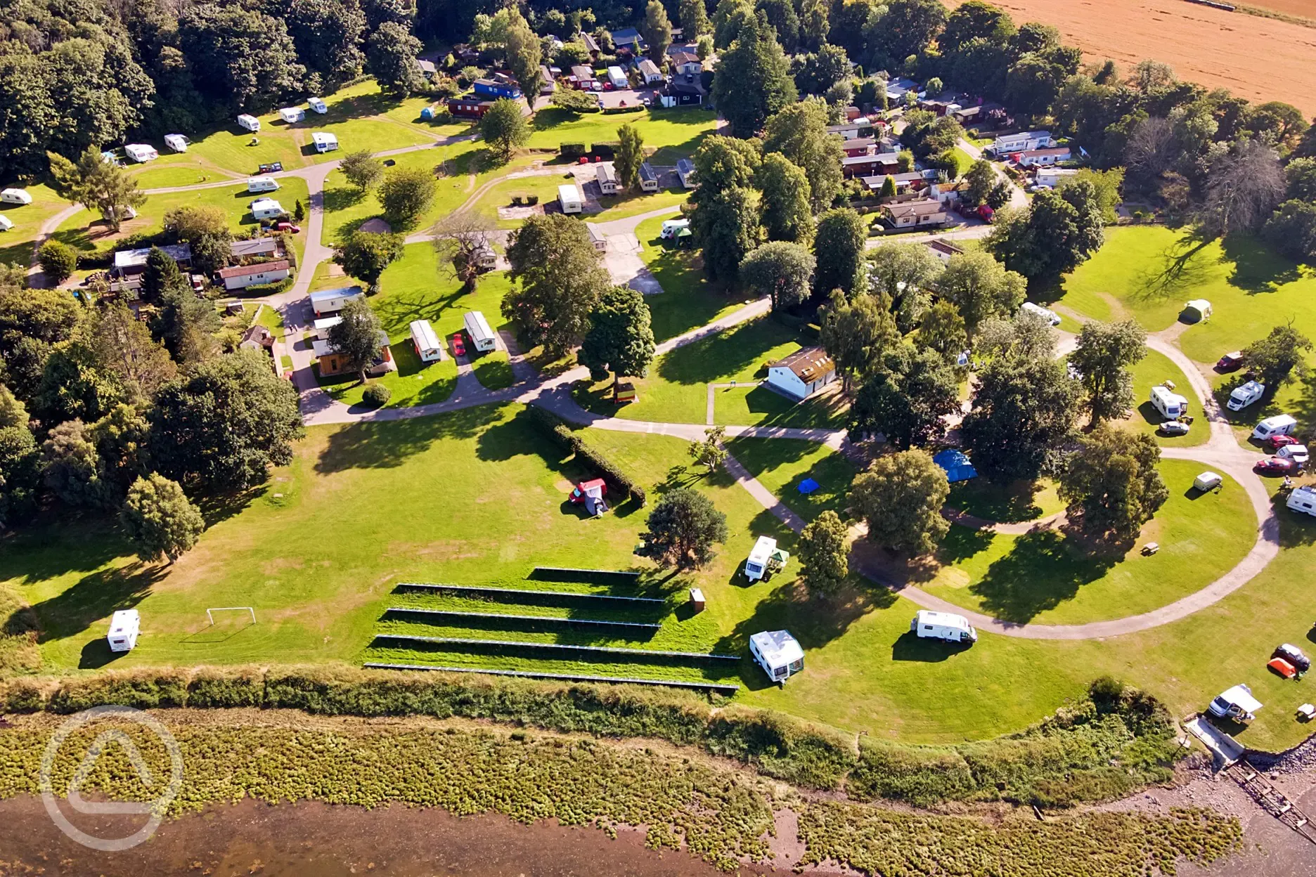 Aerial of Bunchrew Caravan Park with a small shingle beach