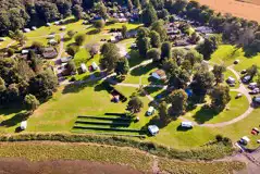 Aerial of Bunchrew Caravan Park with a small shingle beach Aerial of Bunchrew Caravan Park with a small shingle beach