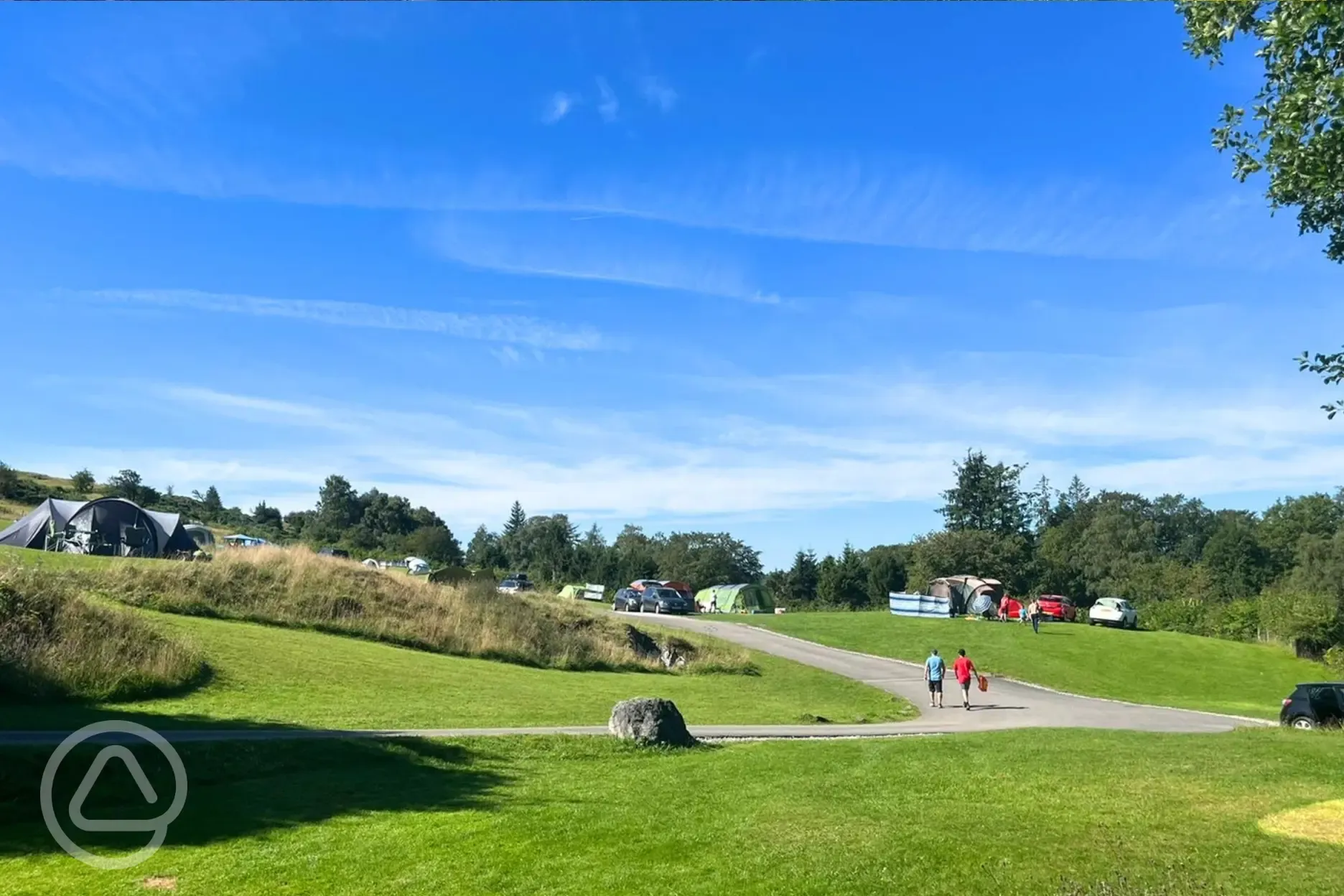 Non electric fellside grass pitches with a central paved road
