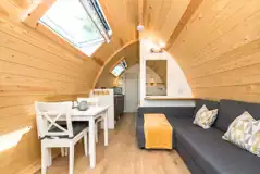 Deluxe glamping pod with a seating area, double sofa bed and seating