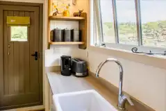 Hut kitchen a Butlers sink, small fridge/ice box, microwave, kettle and toaster