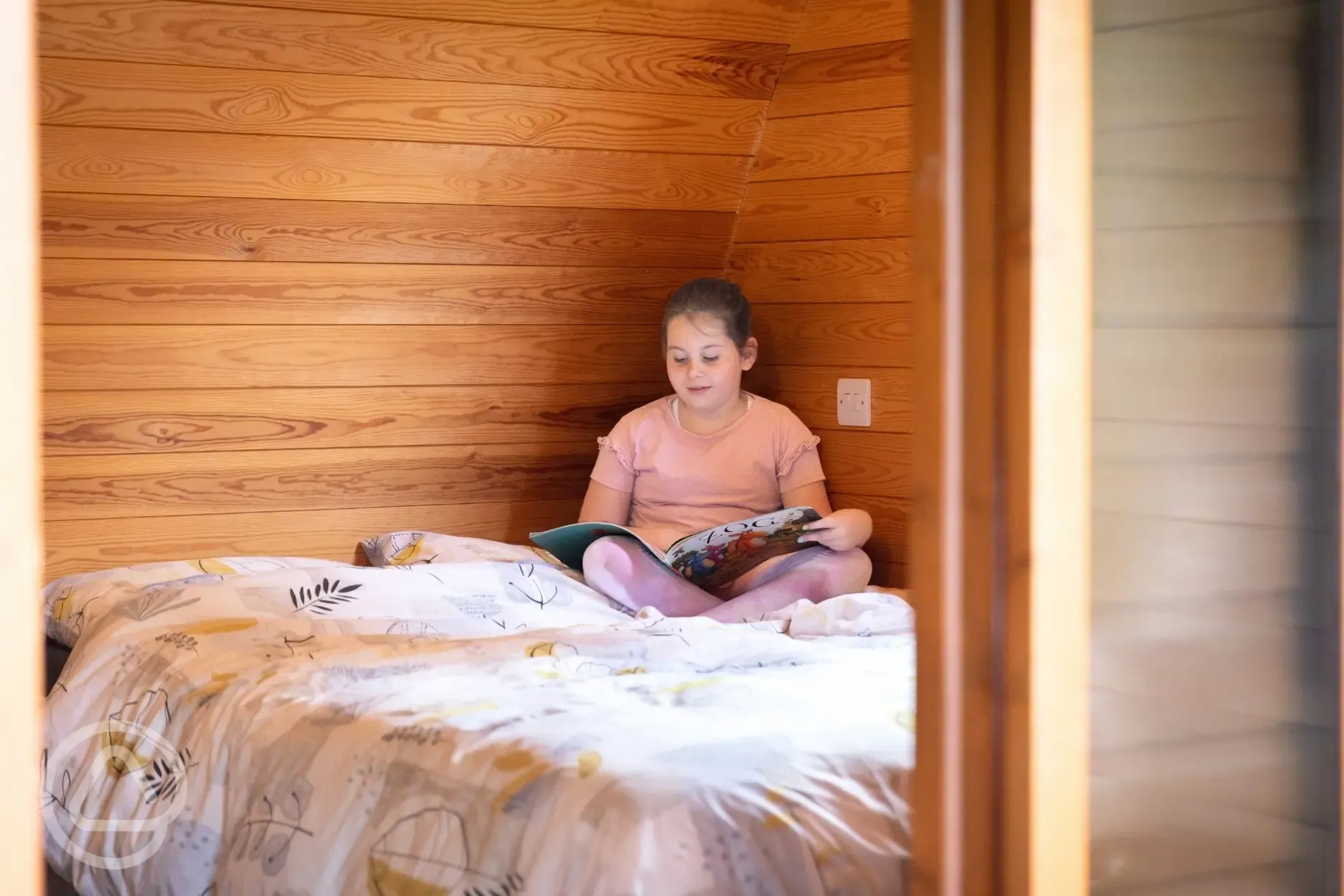 Family Vista camping pod interior with a double bed, bunk beds and trundle bed