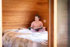 Family Vista camping pod interior with a double bed, bunk beds and trundle bed