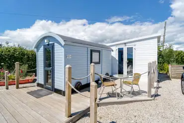 Estuary view shepherd's hut with seating at Parkland Caravan and Camping Site