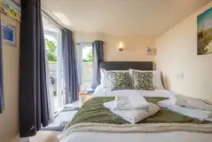 Garden View cabin interior with a 4ft 6"double bed with bedding