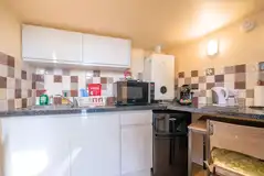 Garden View kitchen with a microwave, fridge/freezer, toaster, kettle, hot plate