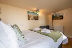 Garden View cabin interior with a 4ft 6"double bed with bedding