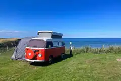 VW campervan on an electric grass pitches with sea views (awnings permitted)