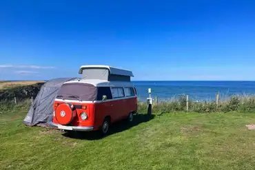 VW campervan on an electric grass pitches with sea views (awnings permitted)