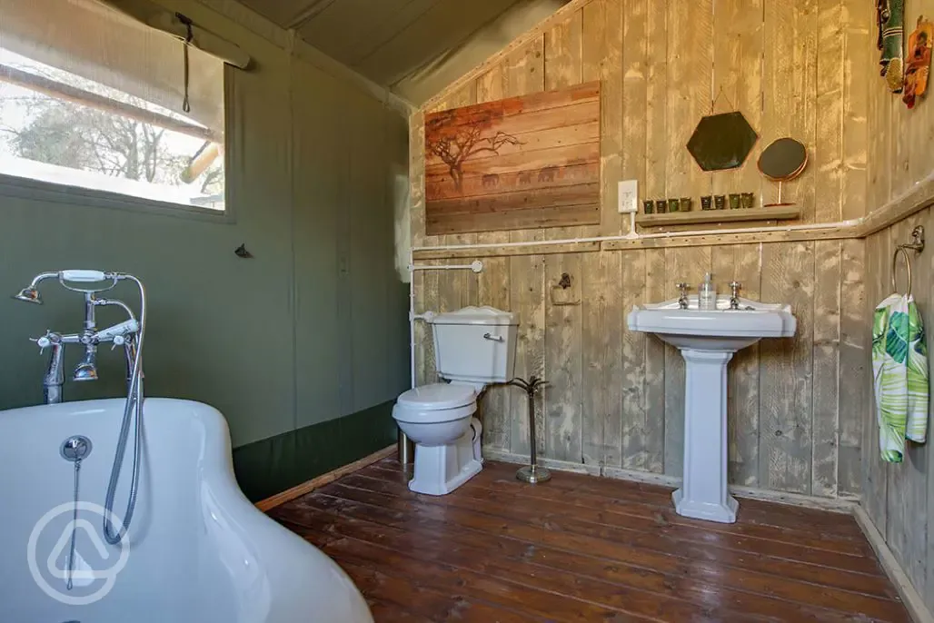 Safari tent bathroom with loo, sink and bath