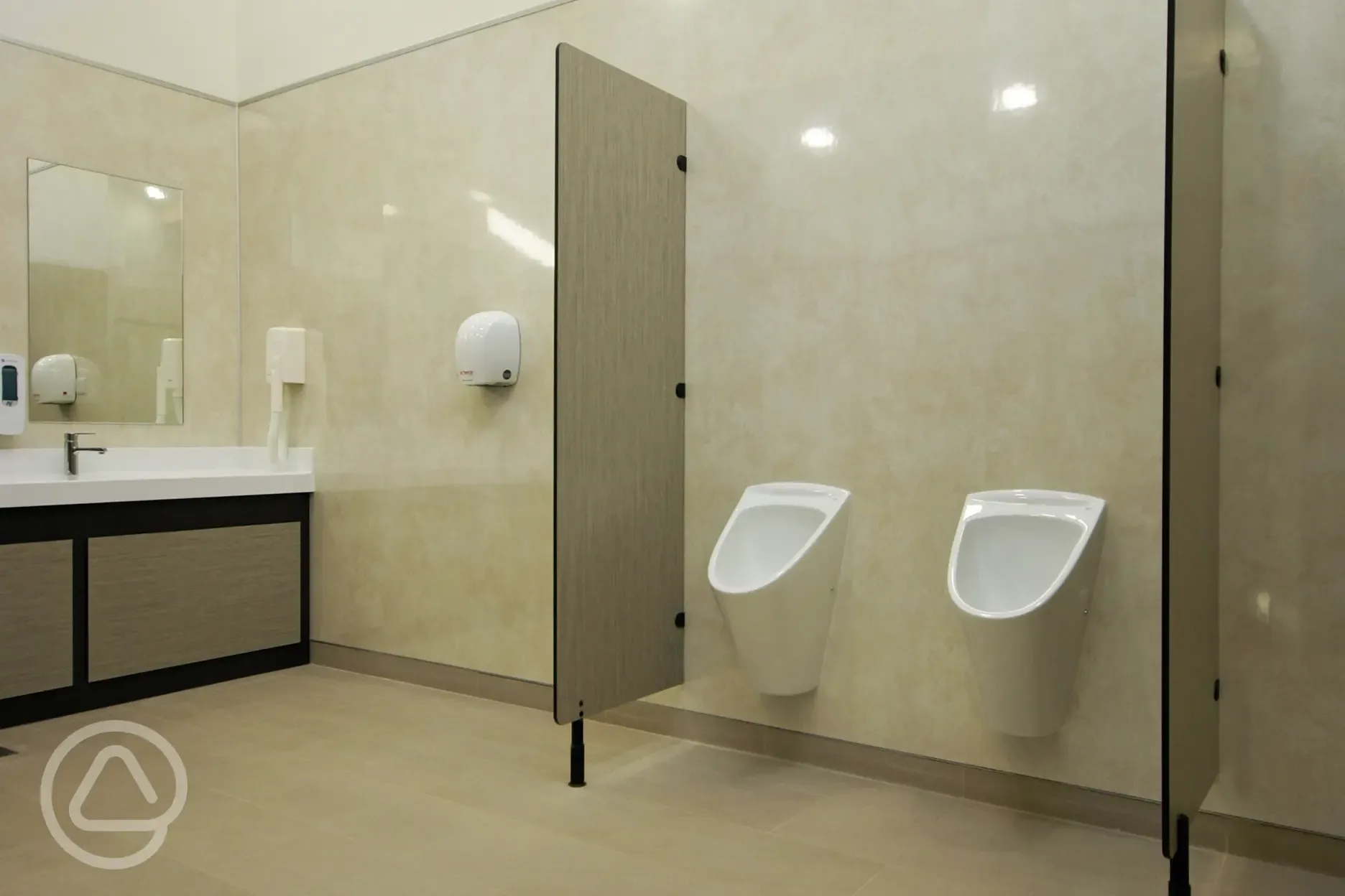 Urinals with sinks and mirrors