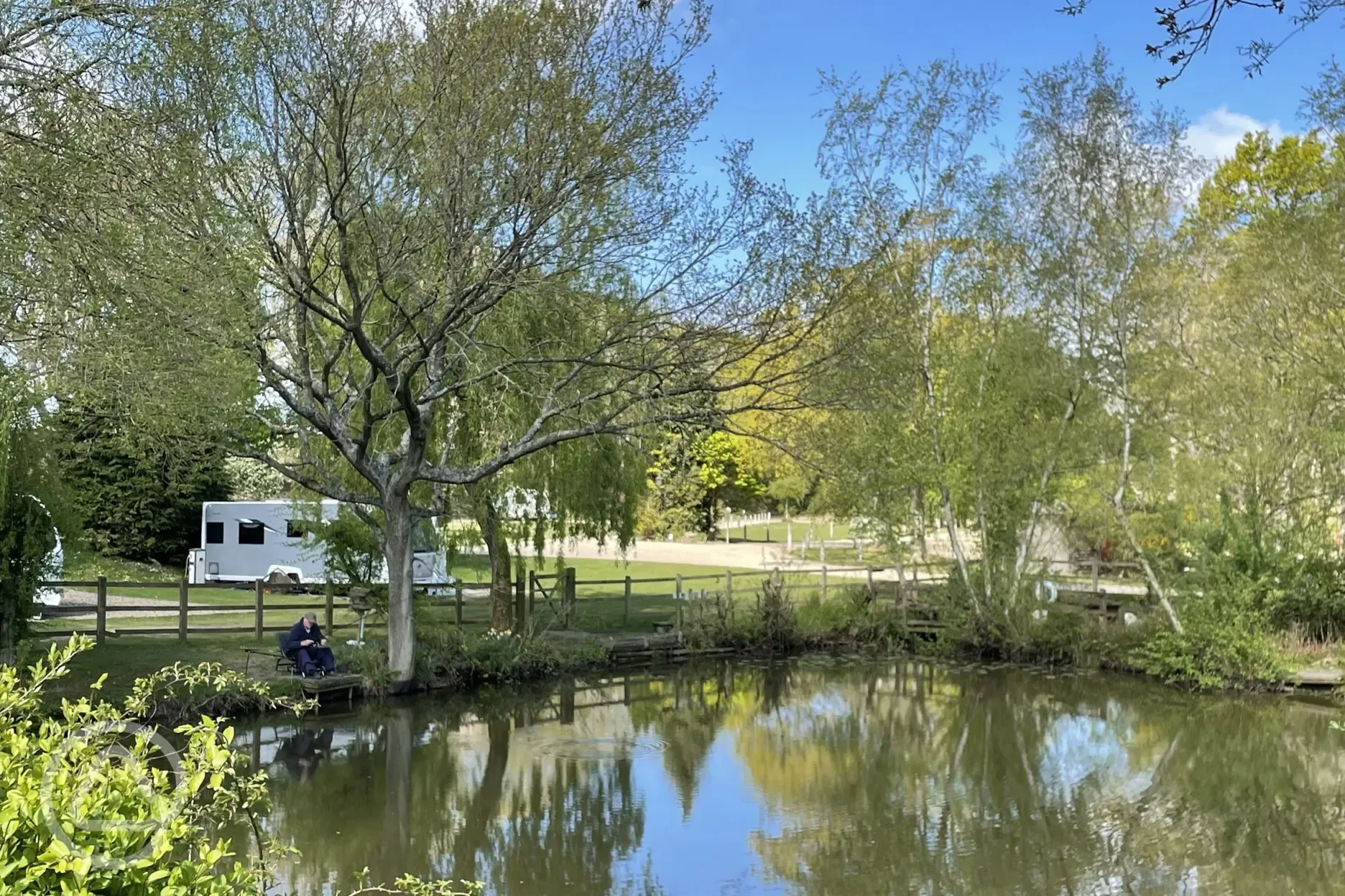 Onsite fishing lake stocked with carp, bream and tench, with a small fee to fish