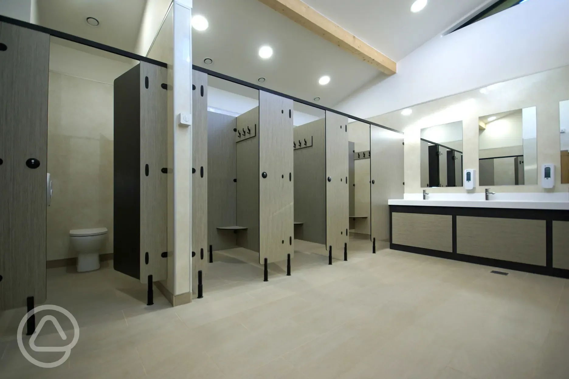 Toilets and showers with sinks and mirrors