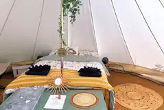 Bell tent with a double bed and two single camp beds (bedding included)