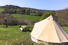 Bell tent with a picnic bench and views over the Lym Valley