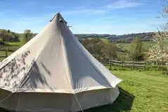 Bell tent with a picnic bench and views over the Lym Valley