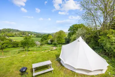 Bell tent at the top of the cider apple orchard with valley views
