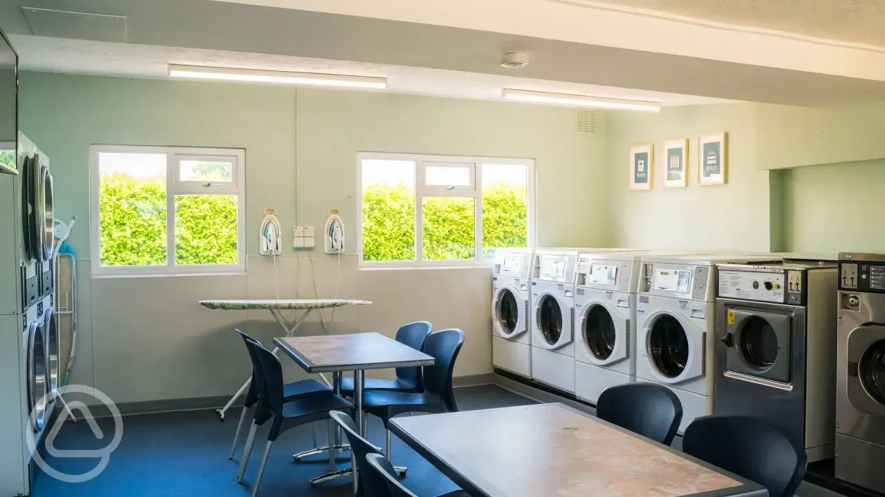 Coin/contactless operated laundry room with washing machines, dryers, and irons