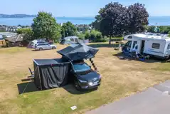 Roof tent on an electric grass pitch
