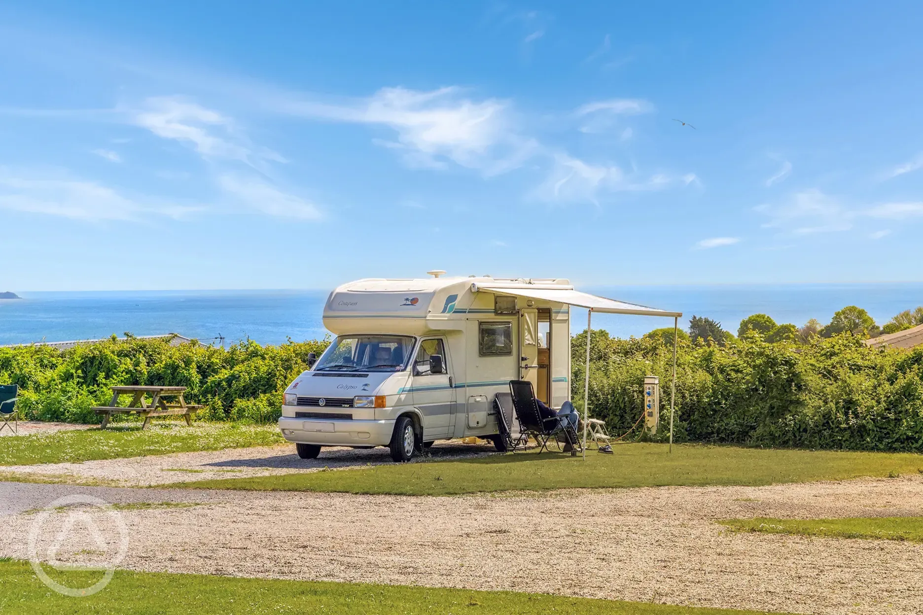 Campervan on a hardstanding pitch with an awning
