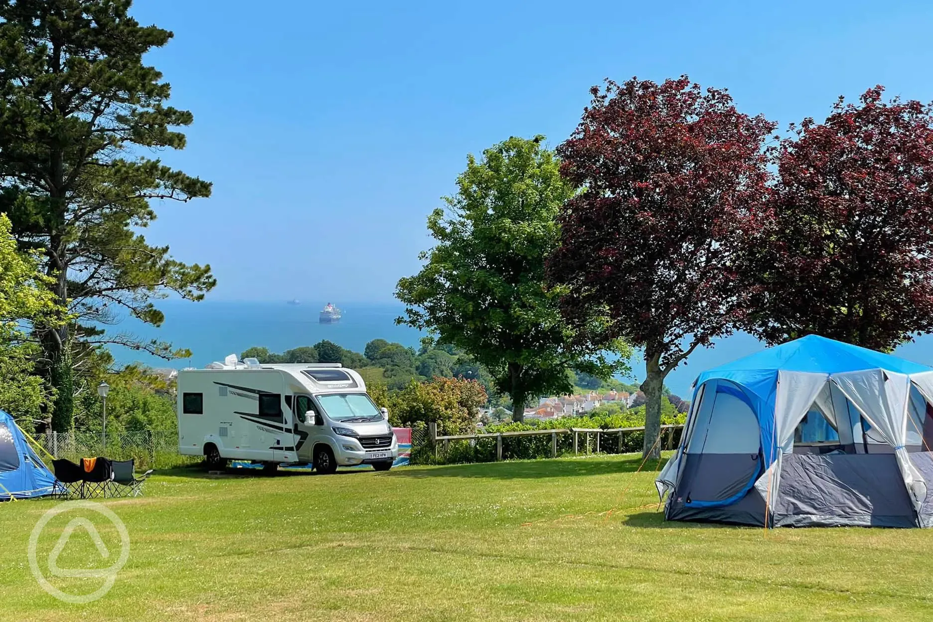 Campervan and tents on electric grass pitches