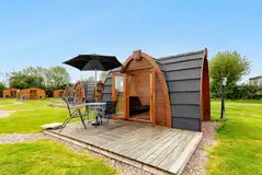 Snug camping pods with deck areas and outdoor seating