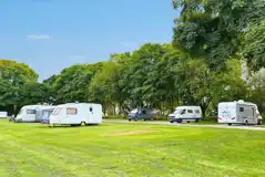 Hardstanding touring pitches with grass surroundings
