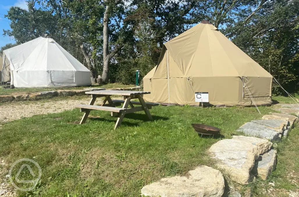 Bell tents with picnic bench and fire pit