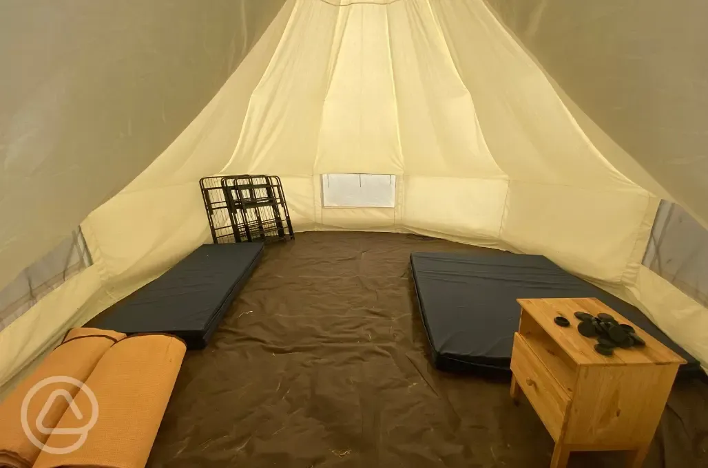 Bell tent interior with single and double mattress