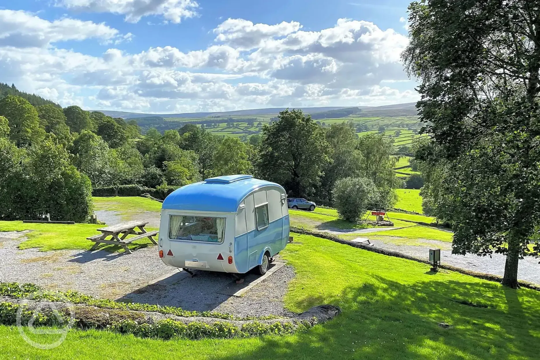 Hardstanding pitch with picnic bench and countryside views