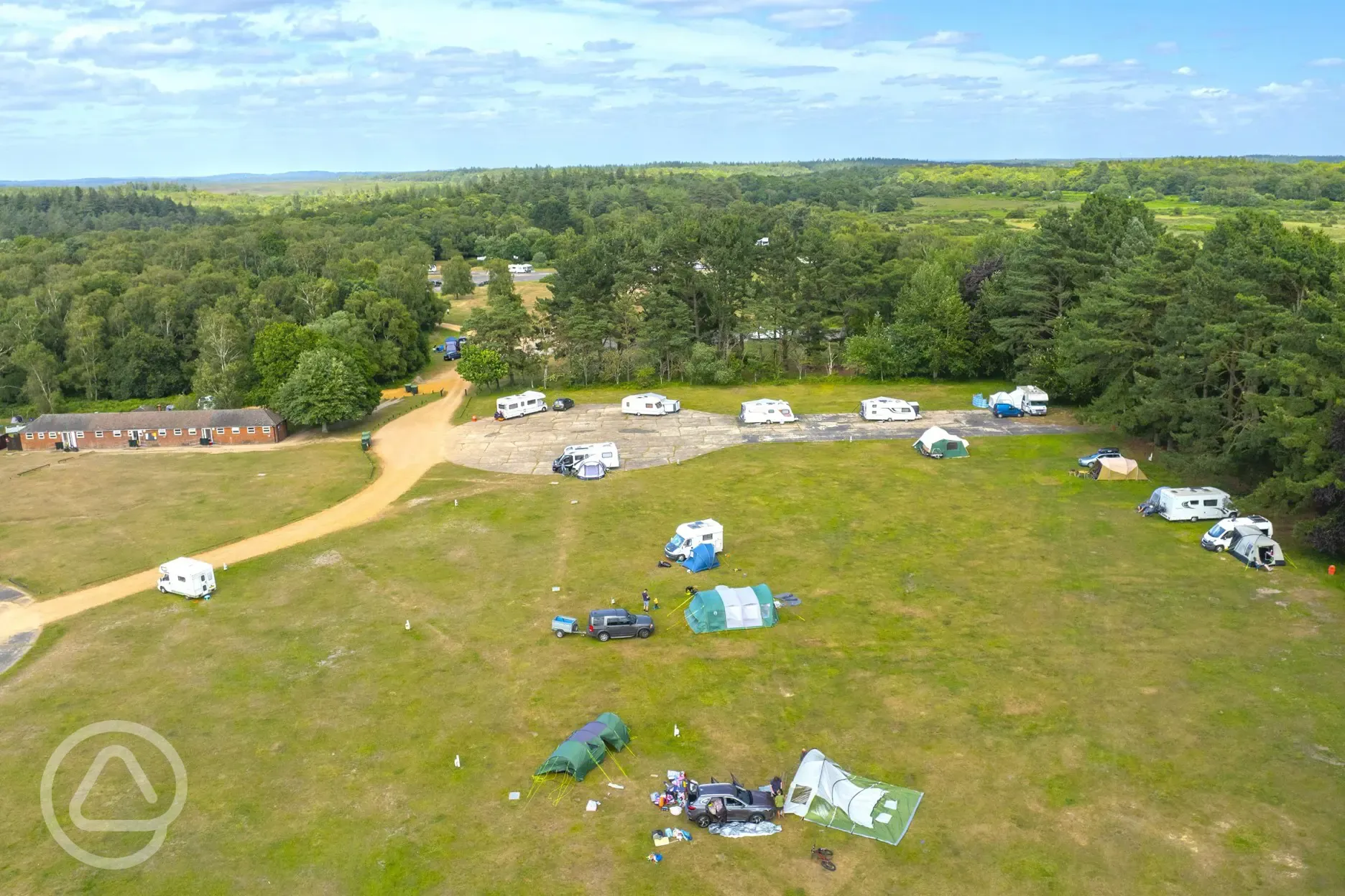 Overview of grass and hardstanding pitches at Holmsley Campsite
