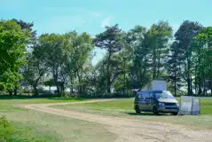 Campervan on an electric grass pitch Campervan on an electric grass pitch