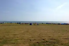 Grass pitches with space for a parked car