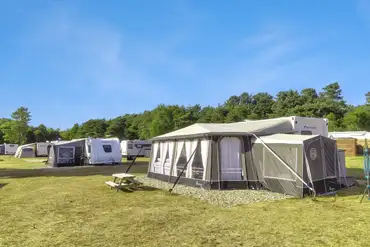 Electric grass or gravel pitches (type C) with picnic benches around site