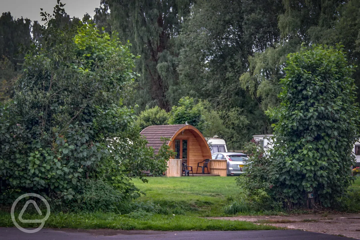 Camping pod from red area surrounded by trees