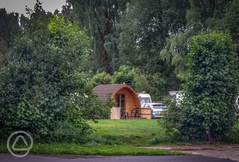 Camping pod from red area surrounded by trees