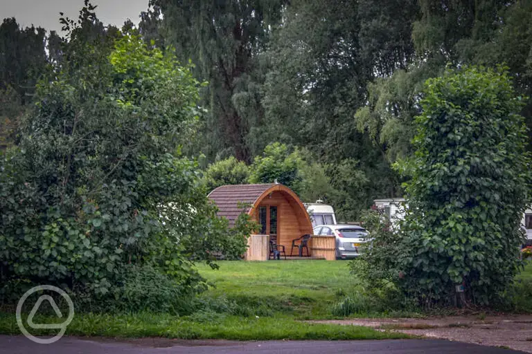 Camping pod from red area surrounded by trees