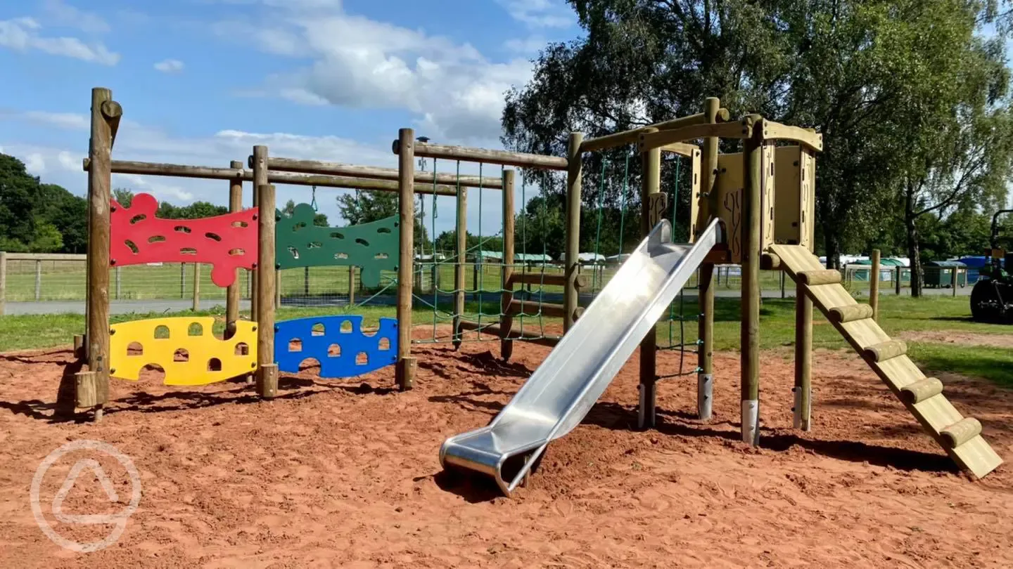 Children's playground in the purple area with climbing frame and slide