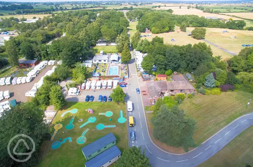 Aerial of the campsite entrance, swimming pool and pitch and putt golf