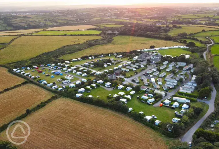 Aerial shot of Lanyon Holiday Park at sunset, surrounded by fields