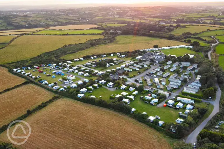 Aerial shot of Lanyon Holiday Park at sunset, surrounded by fields