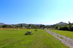Grass pitches with mountain views and picnic benches