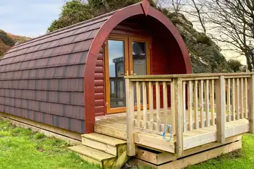 Ensuite glamping pod with a small decking area and double glass doors