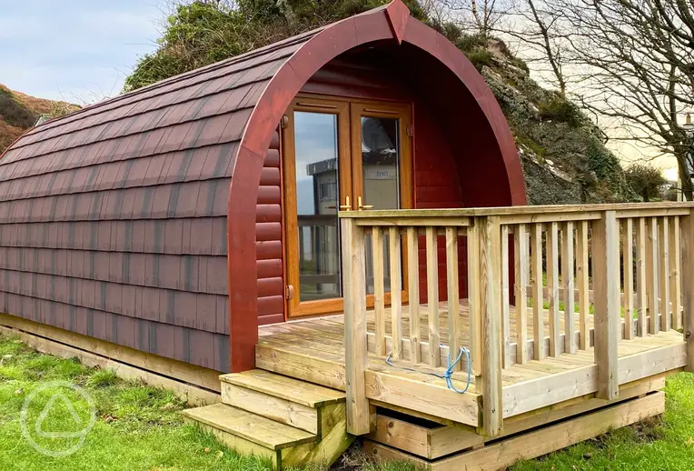 Ensuite glamping pod with a small decking area and double glass doors