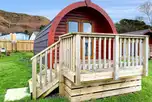 Glamping pods with a small decking area and double glass doors