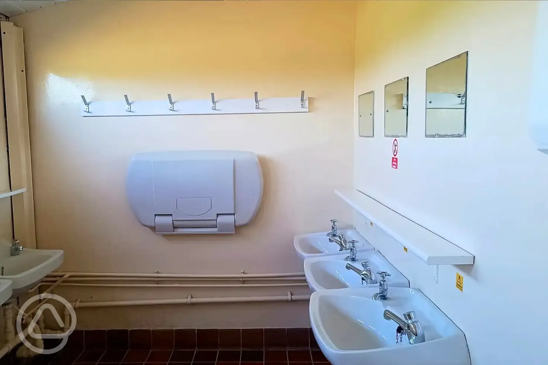 Sinks in the toilets with a baby changing table Sinks in the toilets with a baby changing table