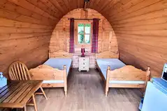 Camping pod with twin beds, a fridge, microwave, kettle, TV/DVD player
