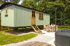 Shepherd's hut with outdoor seating and an electric hot tub
